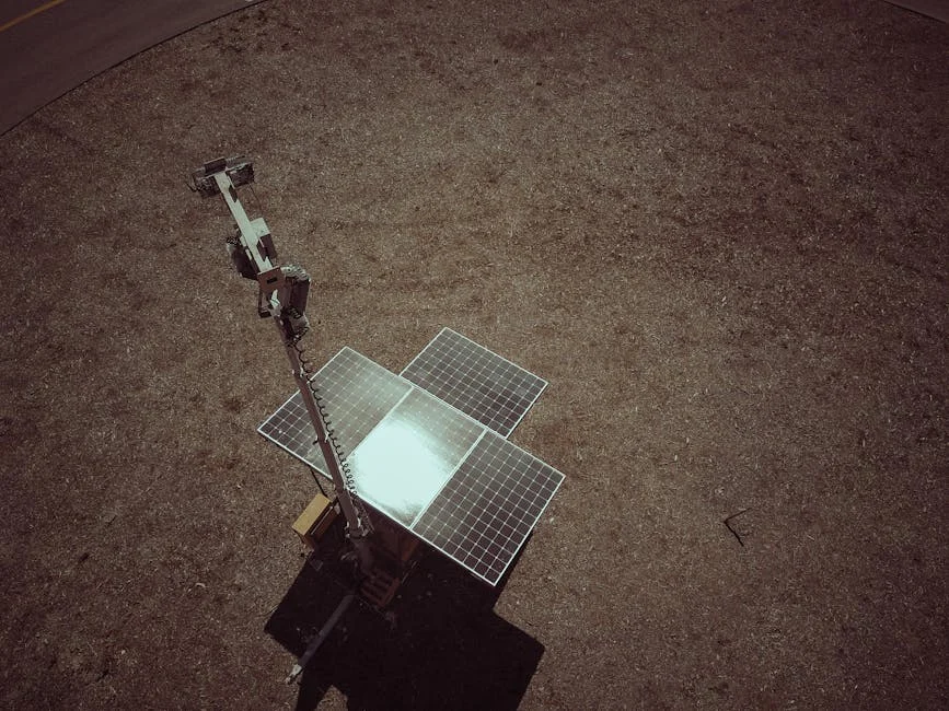 Drone view of solar panels on a dry and barren landscape emphasizing renewable energy.