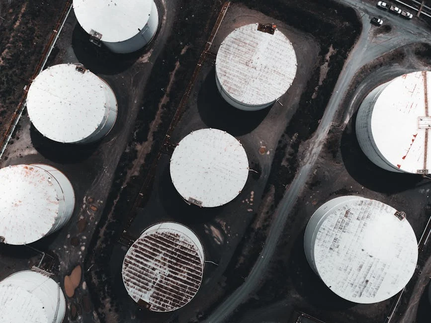 Drone shot showcasing large industrial storage tanks from above.