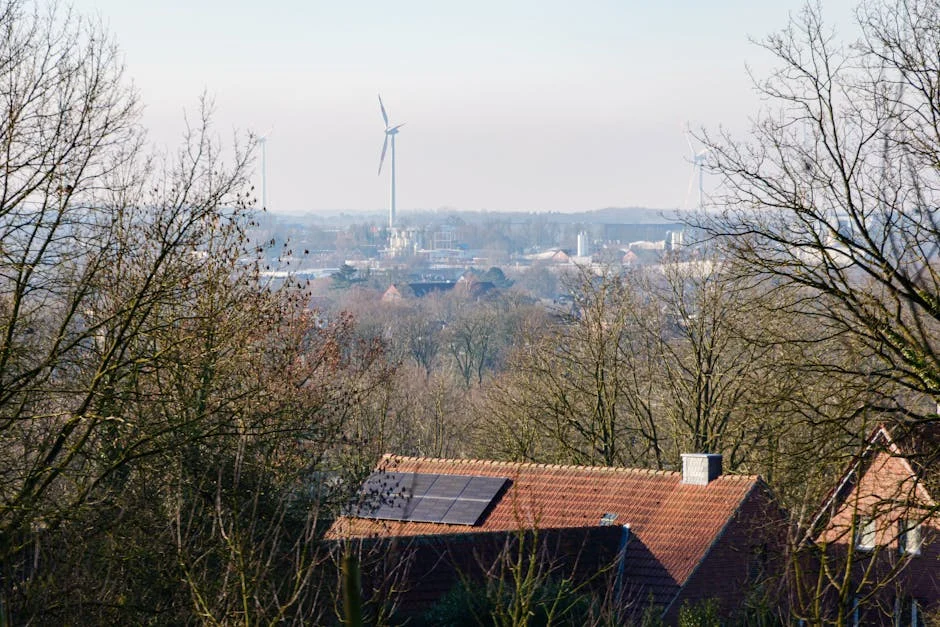 View of Coesfeld with solar panels on rooftops and wind turbines in the distance.
