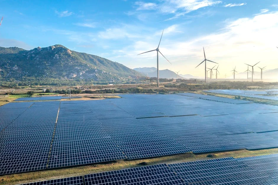Aerial view of a solar and wind energy farm set against Vietnam's scenic landscape.
